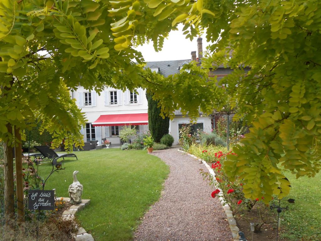 un jardin avec un chemin en face d'une maison dans l'établissement LE RELAIS DU BON'EURE, à Évreux