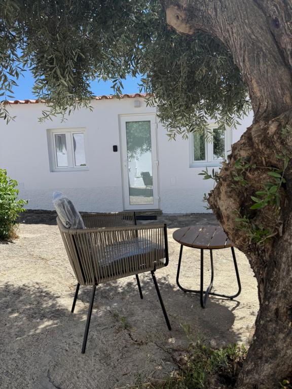 a bench and a table in front of a building at Casa do Pátio in Mértola