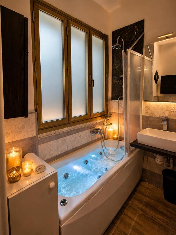a bathroom with a tub with a window and a sink at L'angolo del Viaggiatore 5 Terre in La Spezia