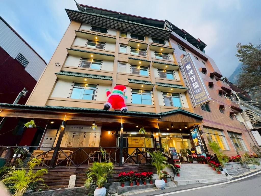 a santa claus sitting on top of a building at 東光行旅 in Xinyi