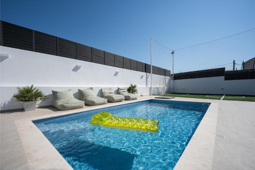 a swimming pool with a raft in the middle at Kaerati Athens in Vari
