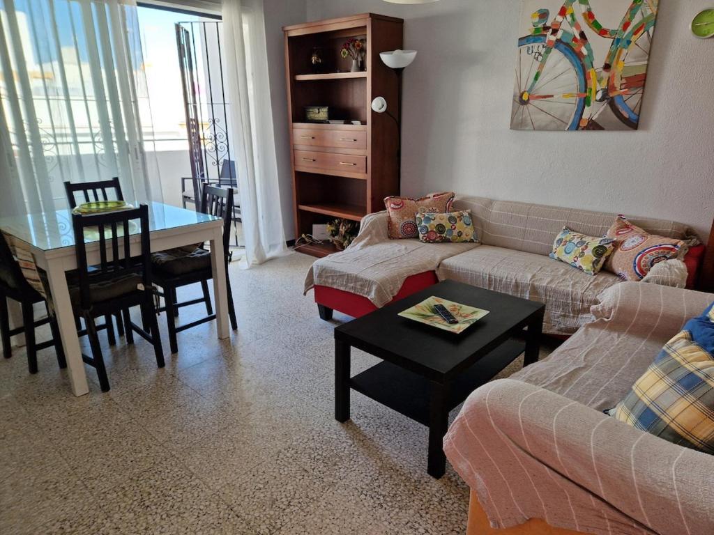 a living room with a couch and a table at Tranquilo y céntrico en Chipiona in Chipiona
