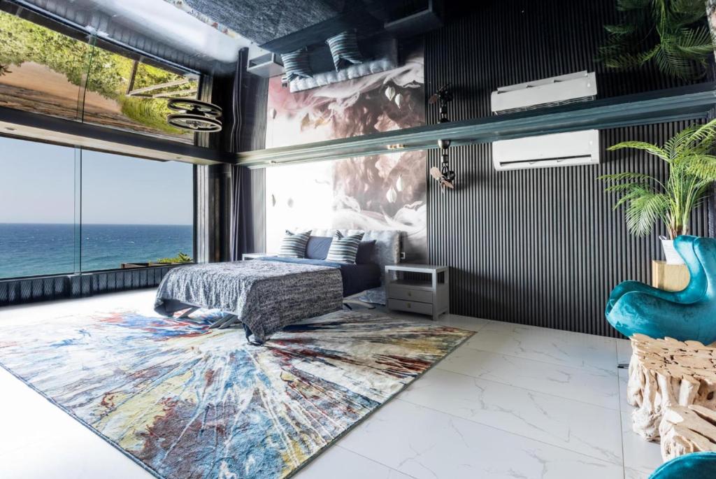a bedroom with a bed and a large rug at Flamenco@Colwyn in Sheffield Beach