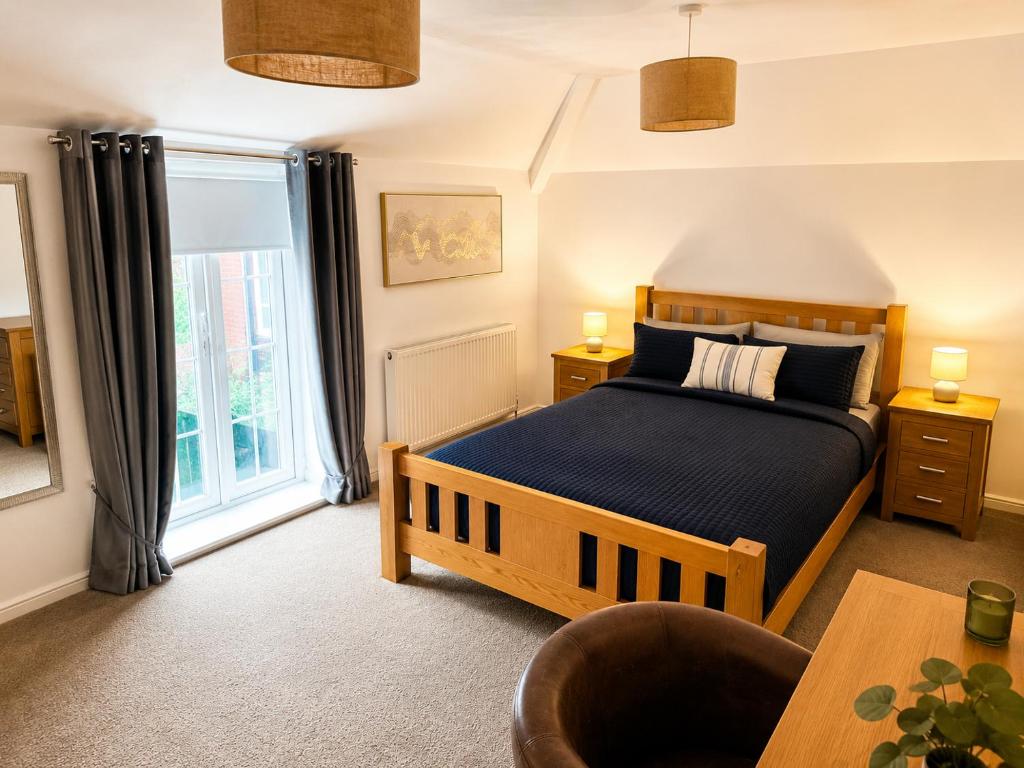 a bedroom with a bed and a large window at Cartref in Caerphilly