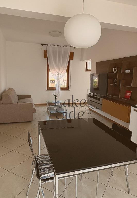 a living room with a table and a couch at Bijou - Lake side apartments in Sandra