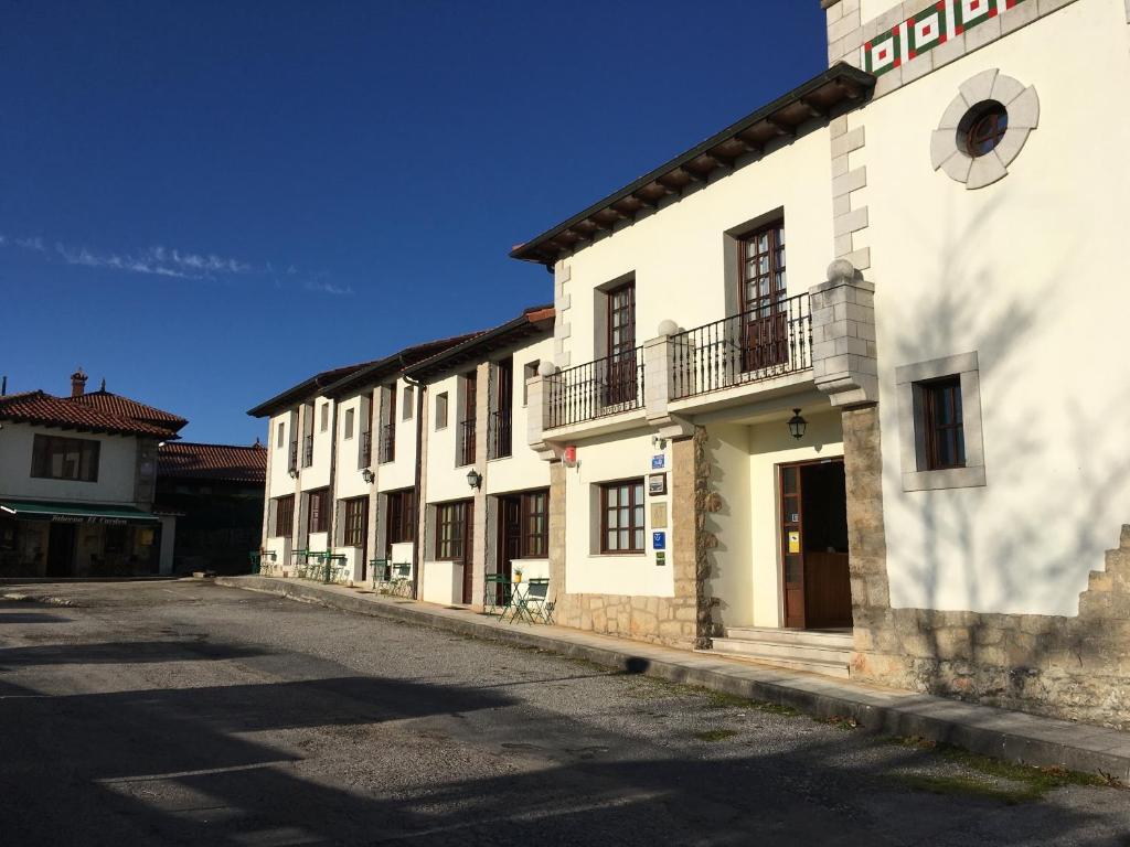 a row of white buildings on a street at El Cardeo in La Revilla