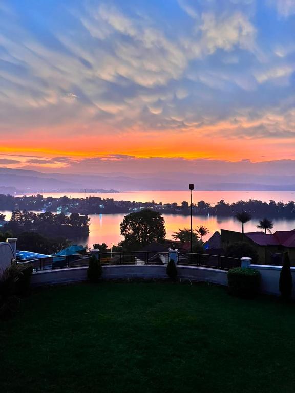 a sunset over a body of water with the horizon at Mona Rusizi in Cyangugu