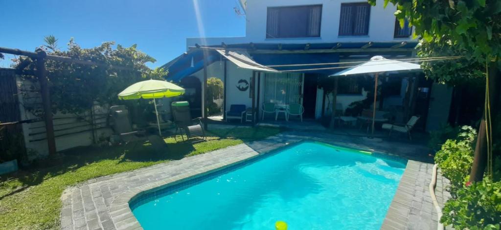 a swimming pool in the backyard of a house at The Owls Nest in Lakeside