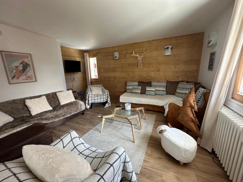 a living room with two couches and a table at le petit sport 2 in La Salle-les-Alpes