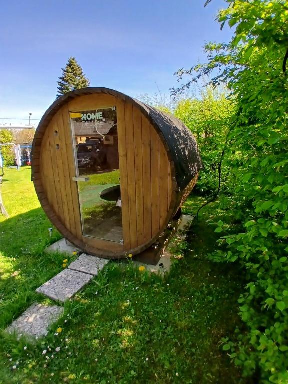 a large wooden hobbit house in the grass at Eva Domizil in Laudesfeld