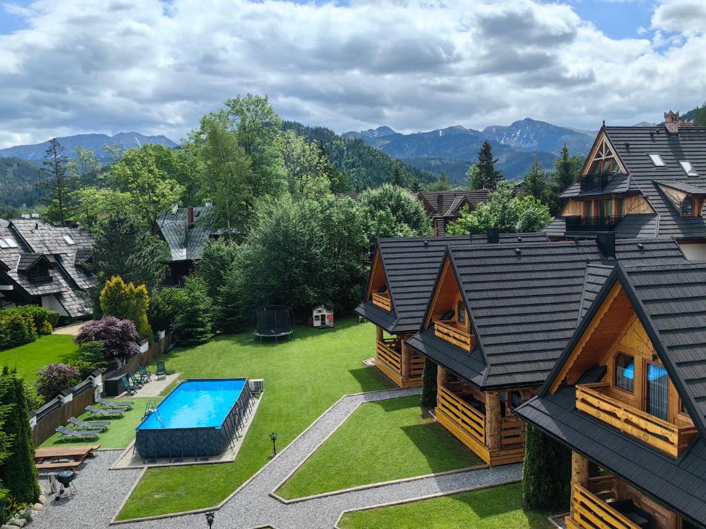 an aerial view of a house with a swimming pool at Janulkowe Domki in Zakopane