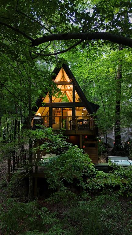 a house in the middle of a forest at Wilewood A-Frame, Romantic Treehouse Getaway, Hot Tub in Abbeville