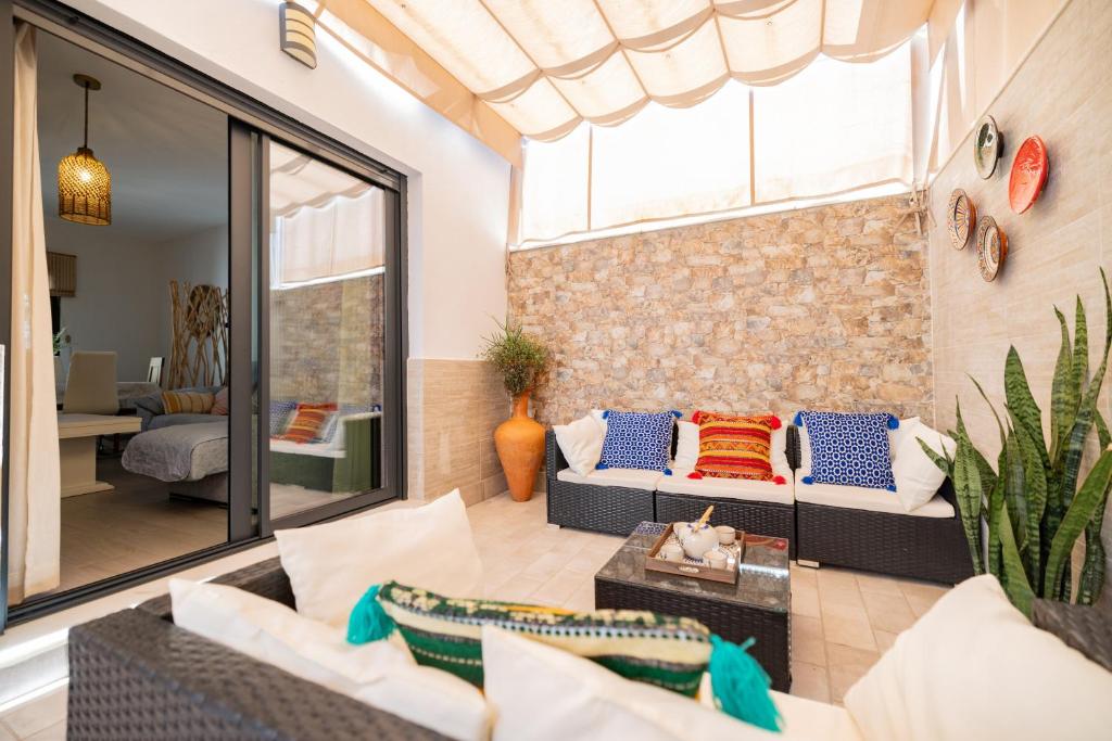 a living room with a brick wall at Casa flor del Rocio in La Rinconada