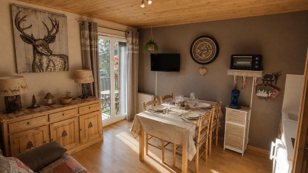 a dining room with a table and a couch at Solarium Mountain Studio 4 People Les Angles in Les Angles