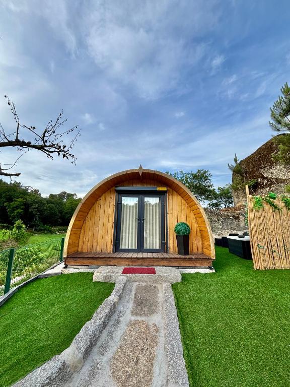 a small wooden house with a window in a yard at Bungalow de Quintas in Marco de Canaveses