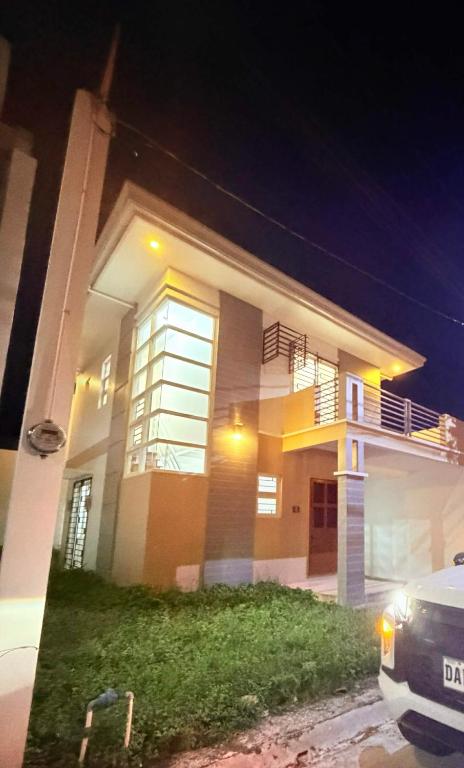 a house at night with a car parked in front of it at Arellano Residence in Batangas City