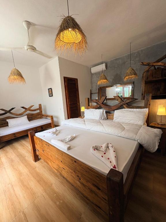 a bedroom with a large bed in a room at NoyaAfrika Kendwa Boutique in Kendwa