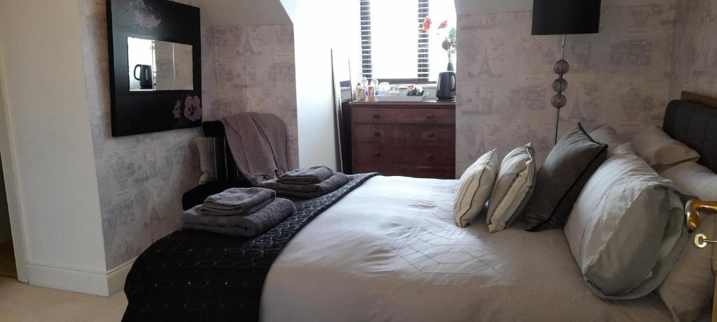 a bedroom with a large bed with pillows on it at Double Bed in Loft Space with En Suite in Loughrea