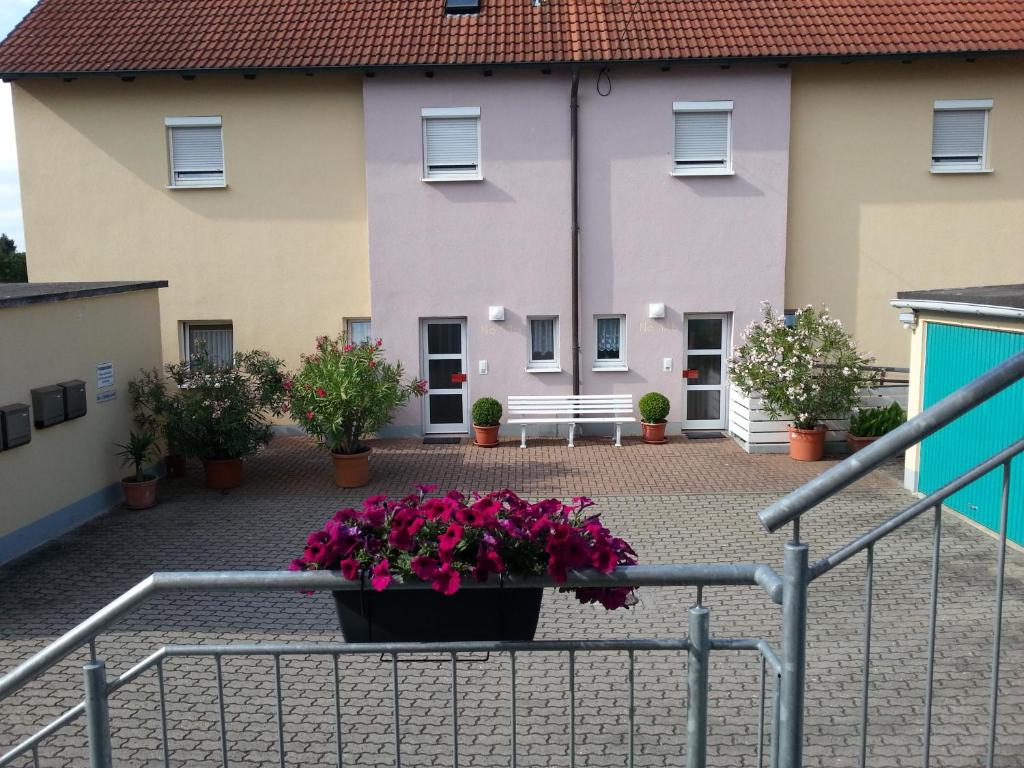 a building with a pot of flowers in the courtyard at Ferienhaus Maria in Breitengüßbach