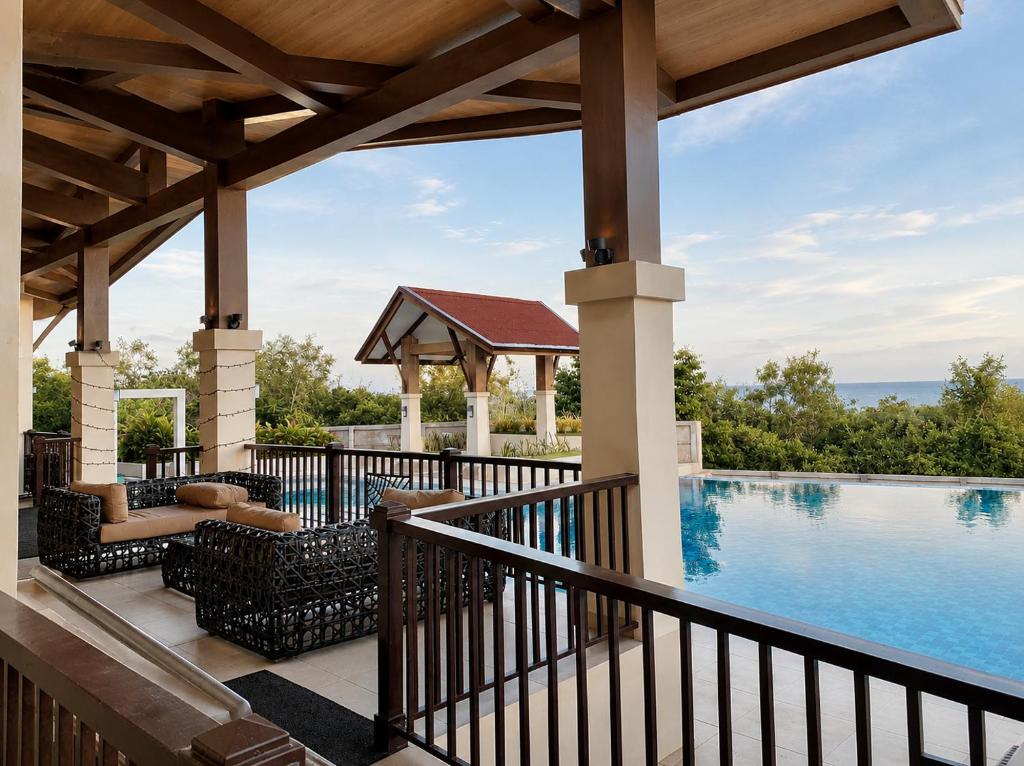 an outdoor deck with a swimming pool and a gazebo at DG Coastal Comfort near Alona Beach - Pool, Gym and Play area in Dauis