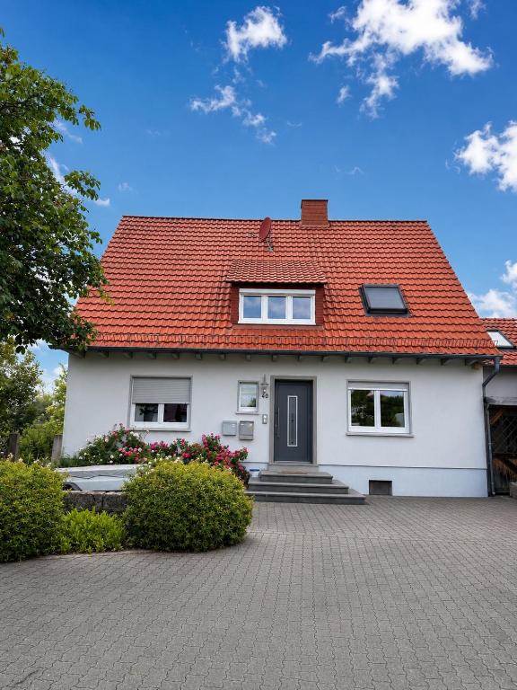 a white house with a red roof at Bimbacher Betten in Bimbach