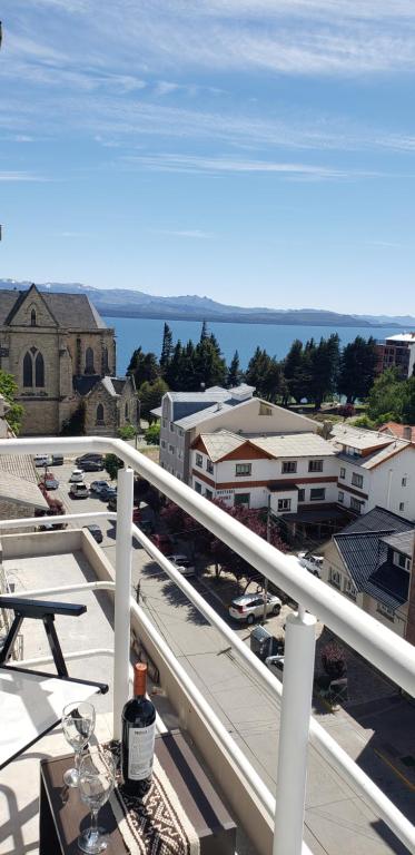 a view of a city from the balcony of a building at Bariloche Apartment in San Carlos de Bariloche