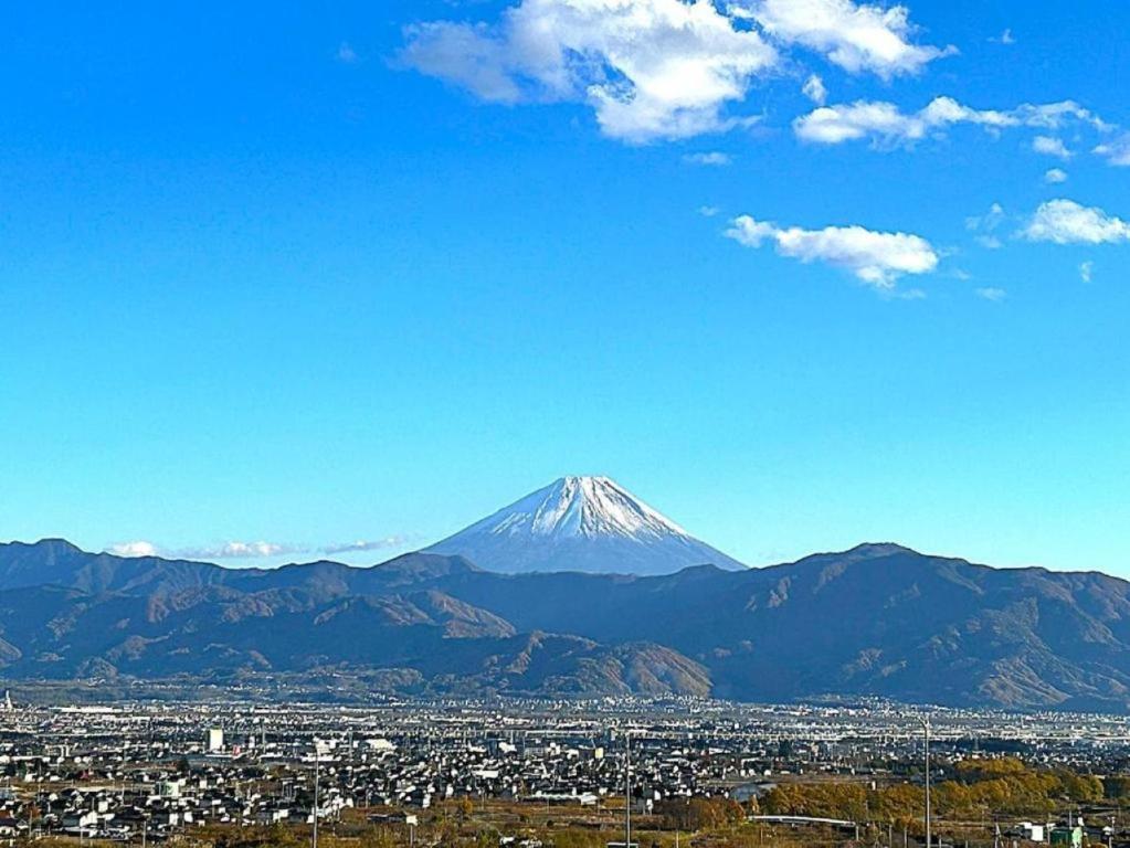 a view of a snow covered mountain in a city at 373アルプスの風 - 最大11名 in Minami Alps