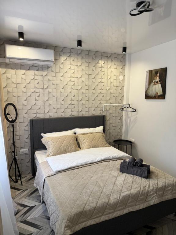 ein Schlafzimmer mit einem großen Bett und einer Steinwand in der Unterkunft Studio Lite Ermou#17 in Kateríni