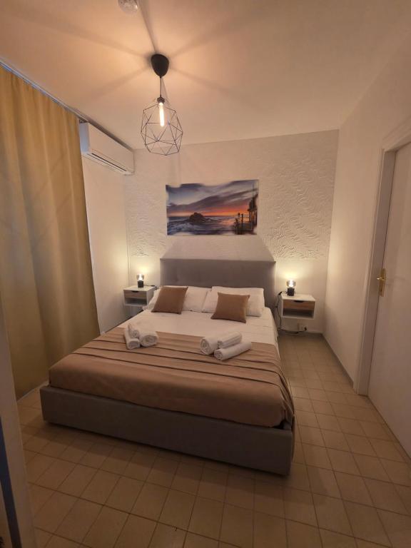 a bedroom with a bed with two towels on it at Monolocale 100metri dal mare in Fano