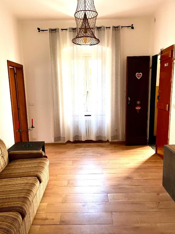 a living room with a couch and a large window at Il Sogno di Giorgio in Chiavari
