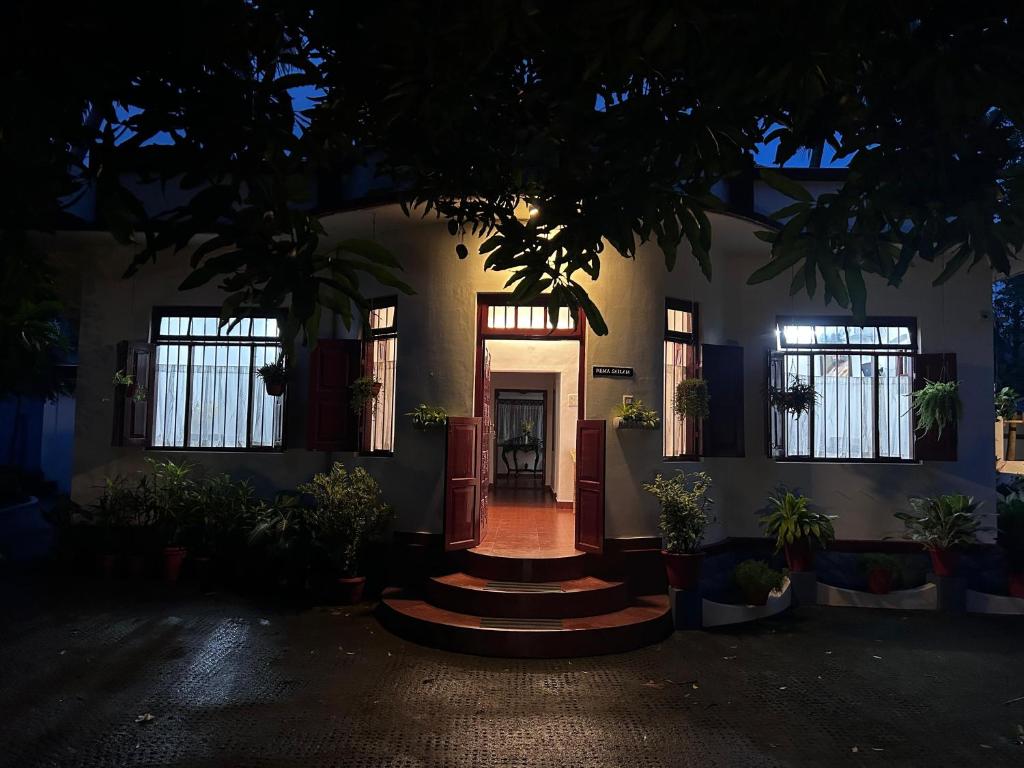 a house with a front door at night at Remasailam Homestay - Thiruvananthapuram , Calm & Blend with Nature in Trivandrum