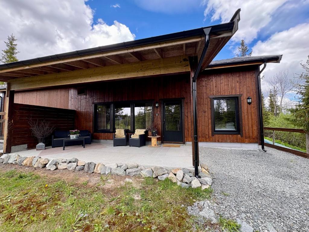 a house with a pavilion with a patio at Mountain Stable Apartment Beito in Beitostøl