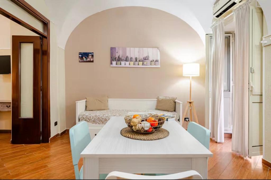 a living room with a table with a bowl of fruit at Dogana House in Catania