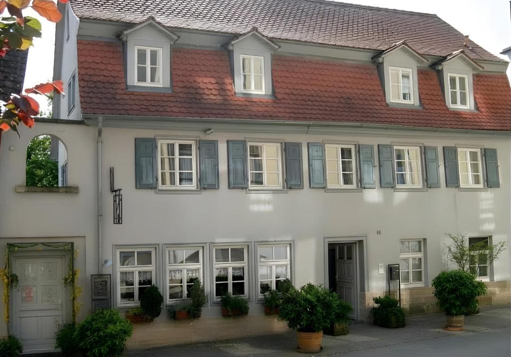a white house with a red roof at Hotel am Kocher in Schwäbisch Hall