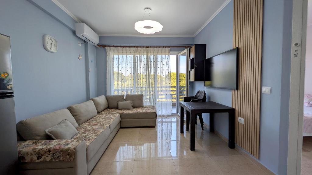 a living room with a couch and a table at Sophi's Dream Apartment in Lalzit Bay