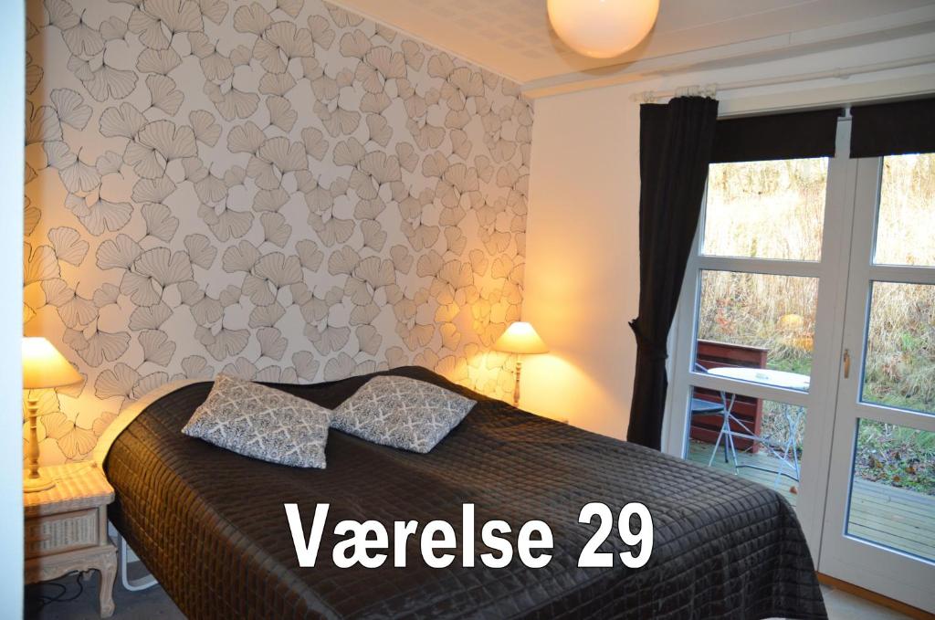 Postel nebo postele na pokoji v ubytování Bromølle Kro