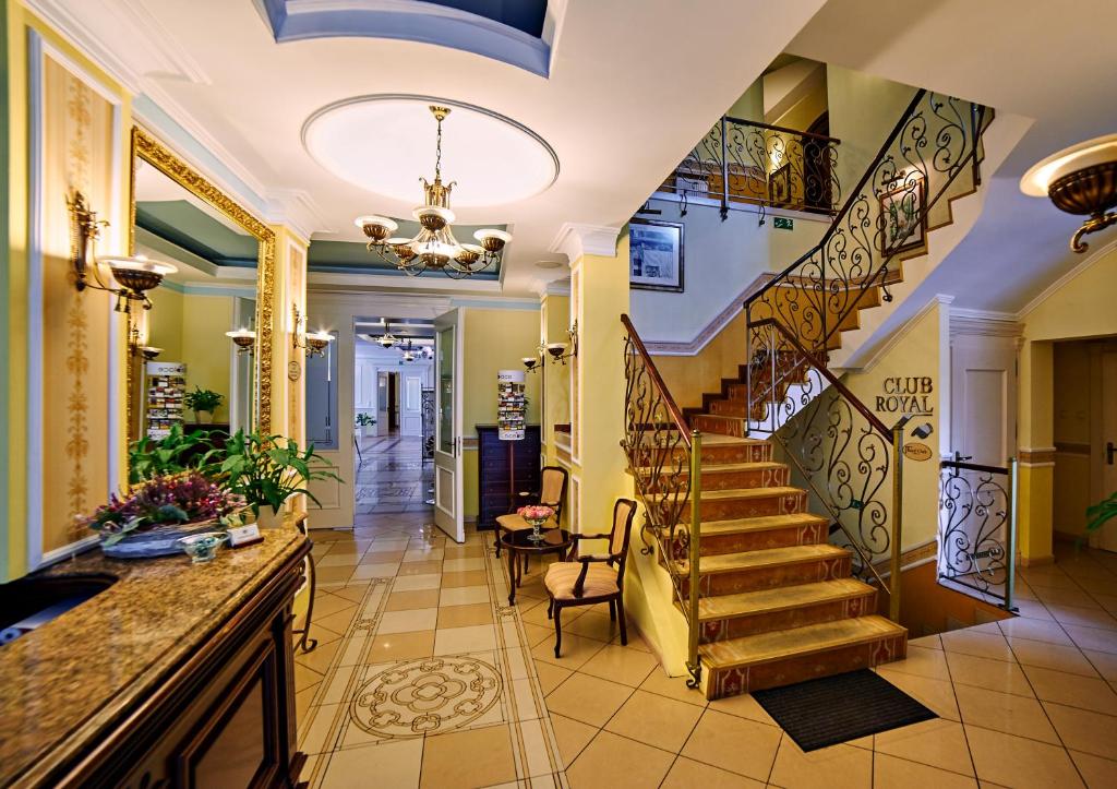 a hallway with a staircase in a house at Villa Royal in Ostrów Wielkopolski