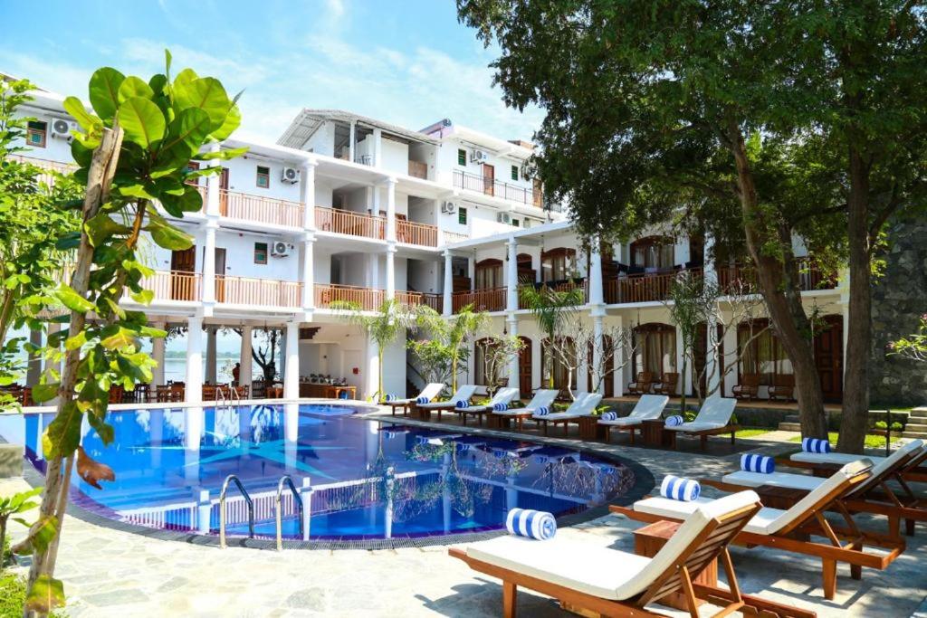 a hotel with a swimming pool in front of a building at Peacock Wild YALA in Tissamaharama