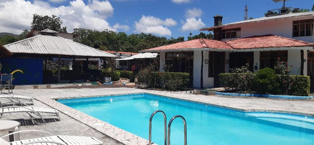 a swimming pool in front of a house at Suymar Ecolodge Galapagos in Puerto Ayora