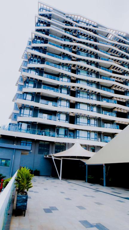 a large apartment building with umbrellas in front of it at Greenland HomeINN in Kigali