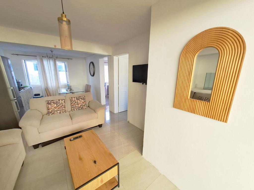a living room with a couch and a table at Cozy South in Mahébourg