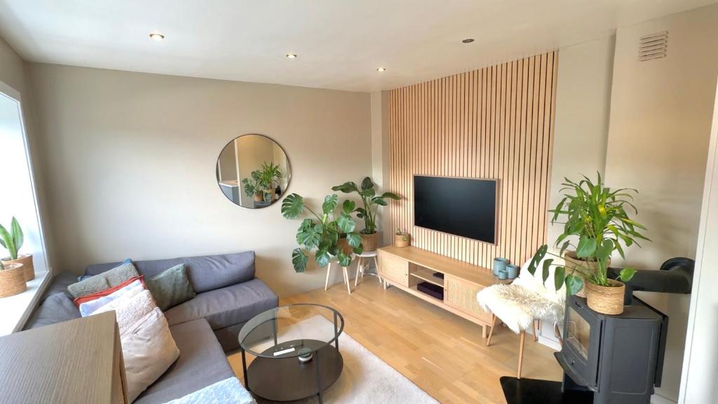 a living room with a couch and a tv at Cozy nest- walking distance to city center in Bergen