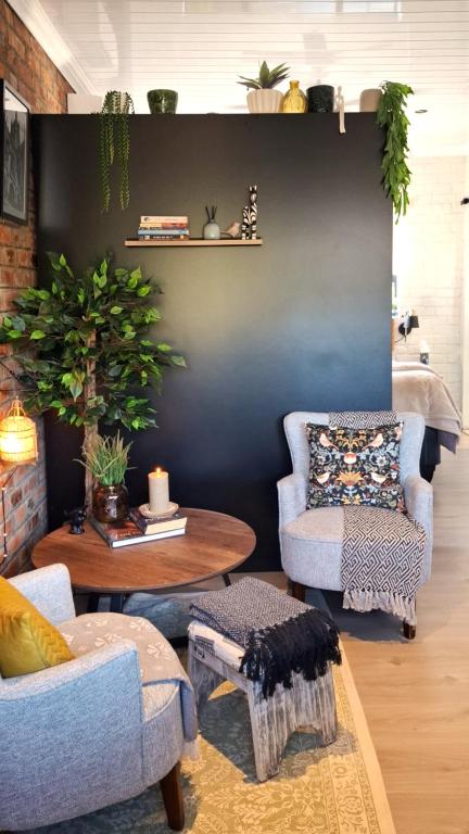 a living room with two chairs and a table at Studio 149 - Wild Coast Accommodation in Sunrise-on-Sea