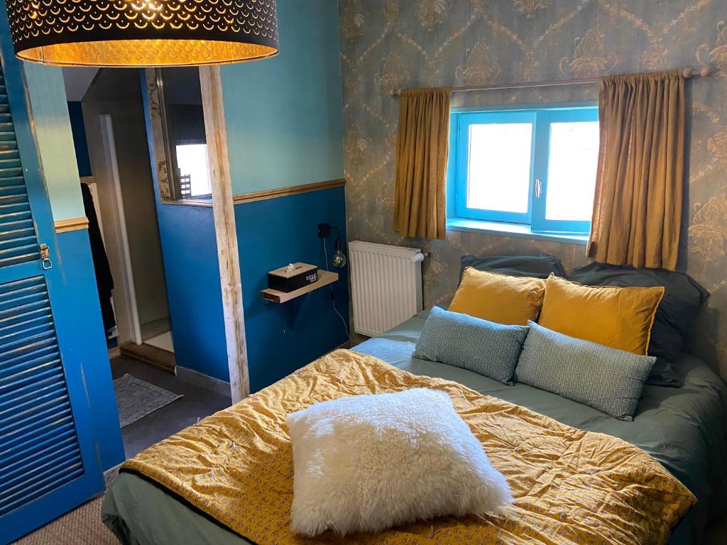 a bedroom with a bed with yellow and blue at Gite L'Atelier in Bèze