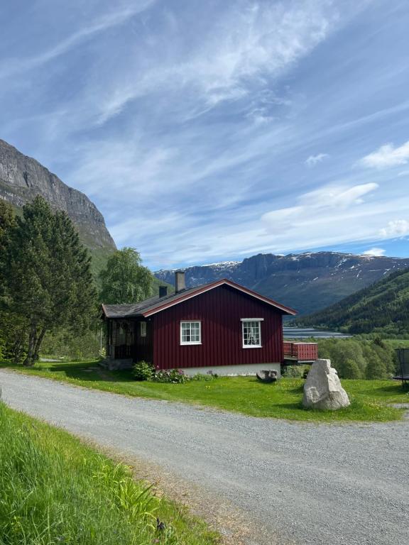 a red house on the side of a road at Bestemorhuset in Øye
