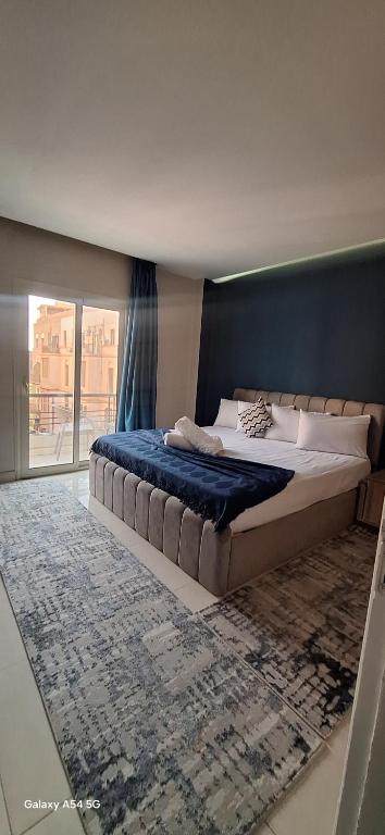 a bedroom with a large bed with a blue wall at Elite Apartment In Cairo Downtown in Cairo