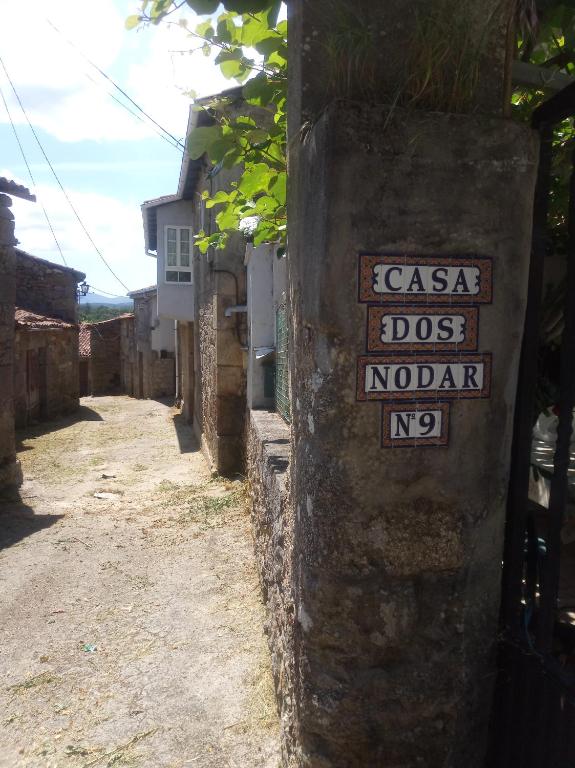 a street with a sign on the side of a building at Casa Nodar in Chantada