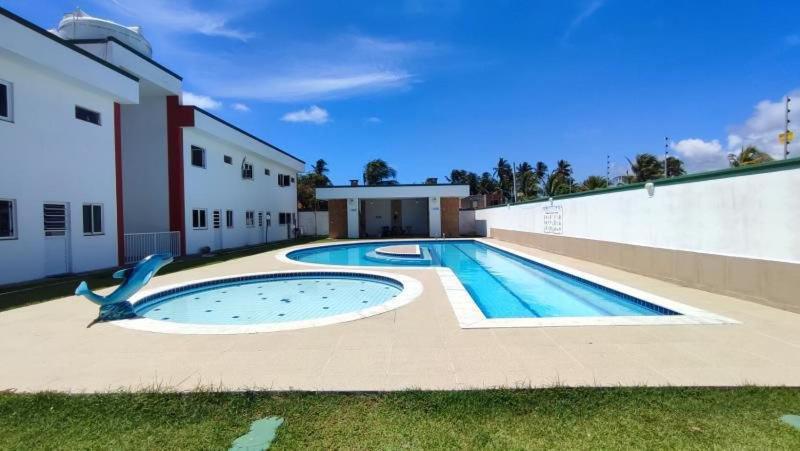 an empty swimming pool in front of a building at Casa de praia in Marechal Deodoro