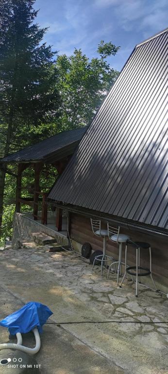 a house with two chairs and a roof at IvanA vikendica,Krupa na Vrbasu in Banja Luka