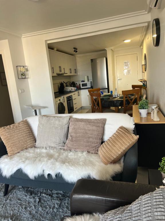 a living room with a couch and a kitchen at Comfortable apartment with balcony and huge pool in Sucina